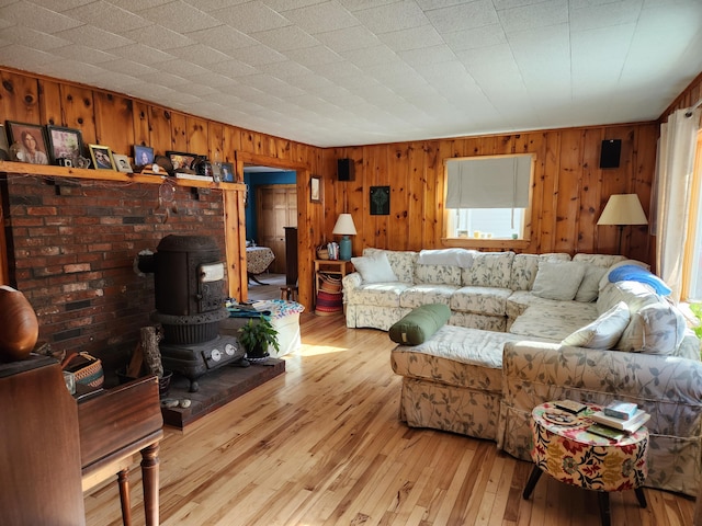 living area with light wood-style flooring and a wood stove