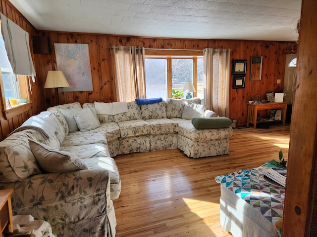 living room with light wood-style floors and wooden walls