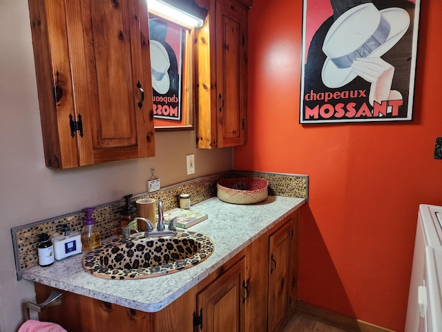 bathroom with a sink and baseboards