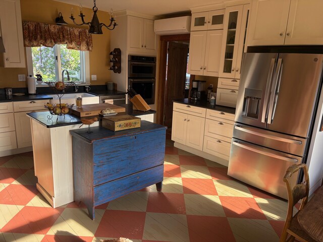 174 Barrett Hill Rd, Union, ME 04862 - kitchen with stainless steel fridge with ice dispenser, dark countertops, a wall unit AC, glass insert cabinets, and white cabinets