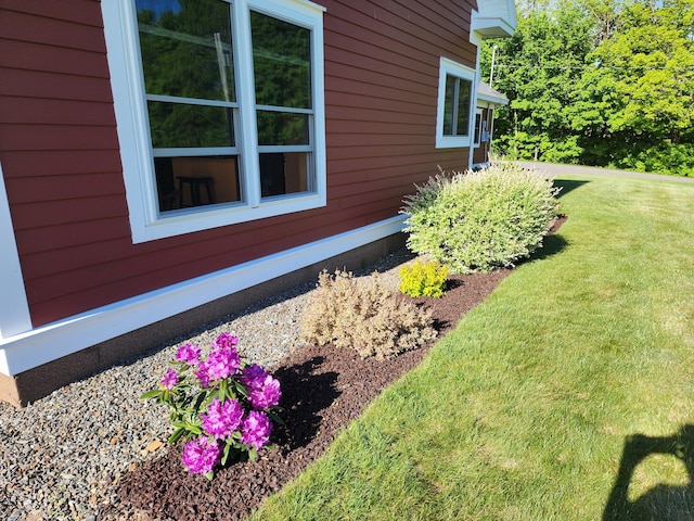 view of home's exterior with a yard