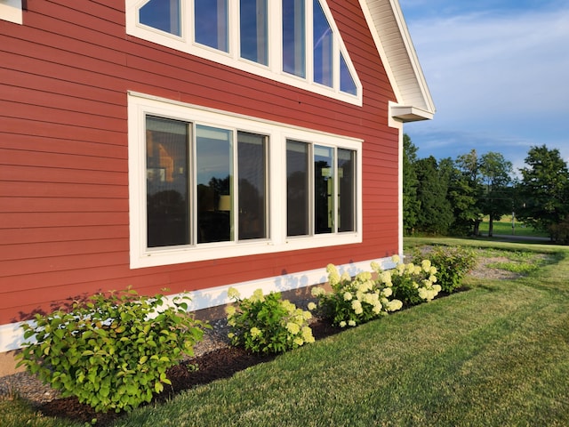 view of side of home with a yard