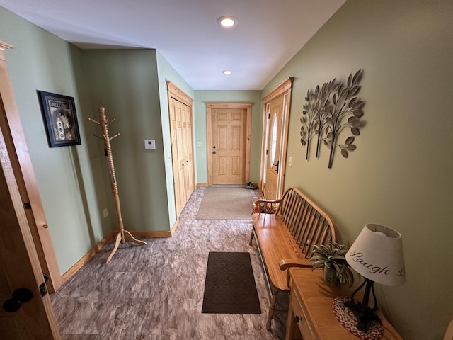 hallway featuring recessed lighting and baseboards