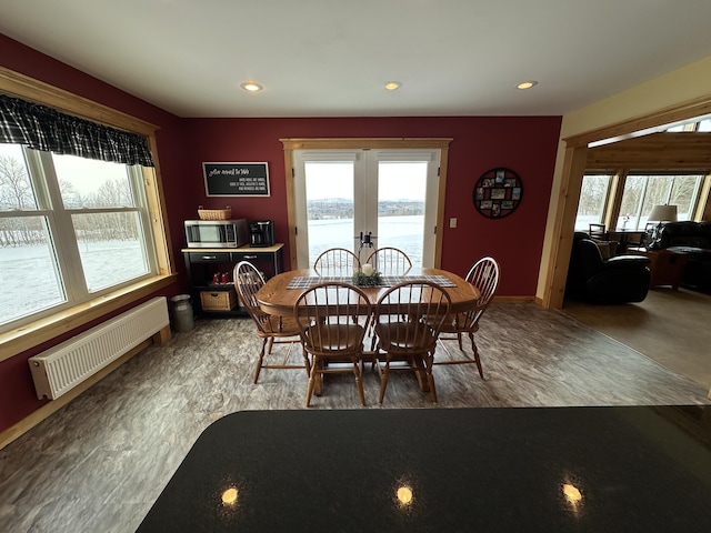 dining room with a wealth of natural light, french doors, radiator heating unit, and recessed lighting