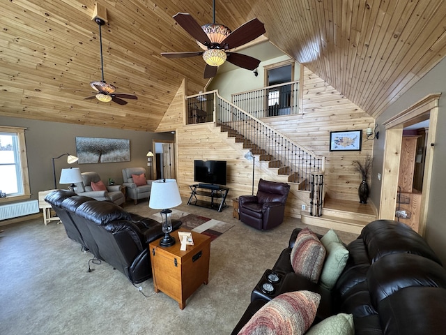 living area with wooden ceiling, wooden walls, and carpet flooring