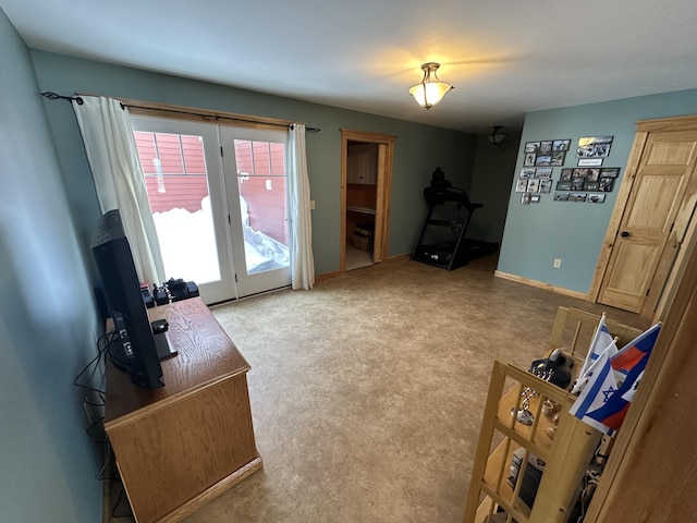 carpeted living room with baseboards