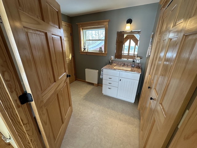 bathroom with vanity and baseboards