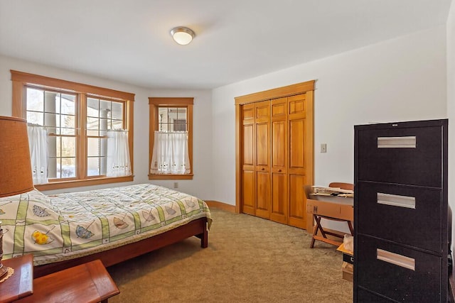 bedroom featuring a closet and light colored carpet