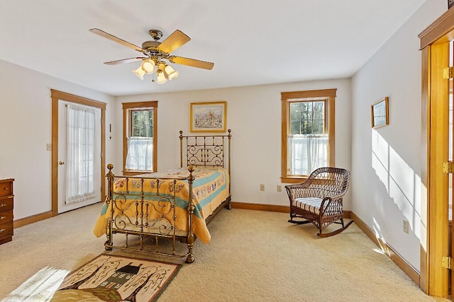 bedroom featuring a ceiling fan, light carpet, and baseboards