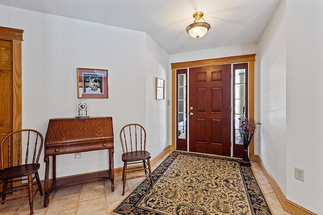 entrance foyer featuring baseboards and light tile patterned floors