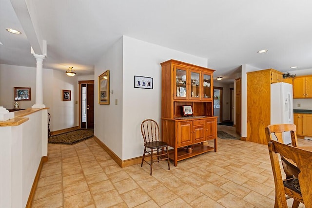 dining area featuring ornate columns, baseboards, and recessed lighting