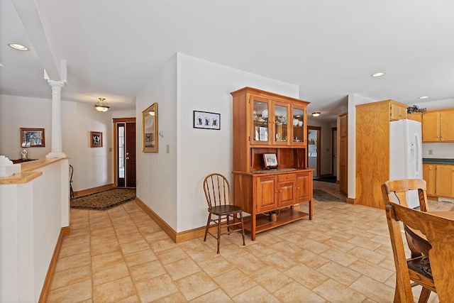 dining space featuring baseboards, decorative columns, and recessed lighting