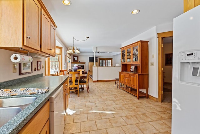 kitchen featuring brown cabinets, recessed lighting, white appliances, baseboards, and ceiling fan with notable chandelier