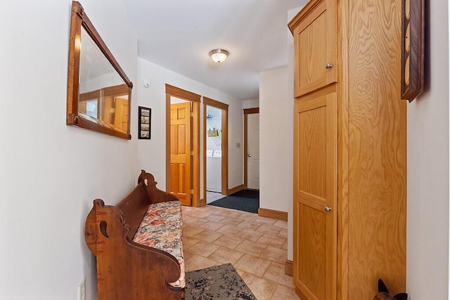 entrance foyer with baseboards and washer / clothes dryer