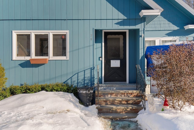 view of snow covered property entrance