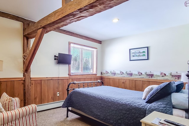 bedroom featuring wooden walls, wainscoting, beamed ceiling, carpet, and a baseboard heating unit