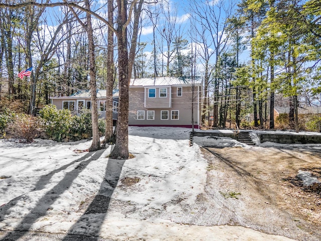 back of house with metal roof