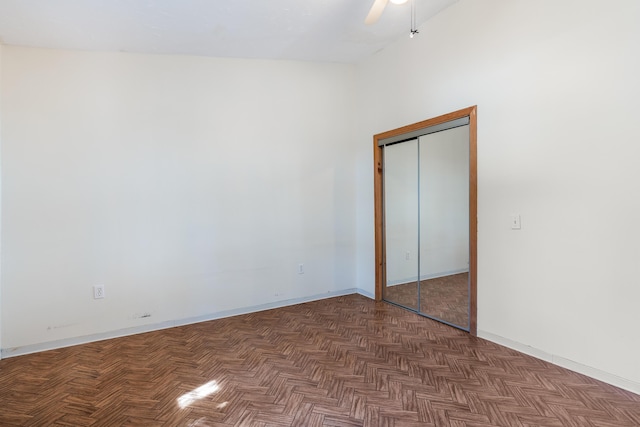 unfurnished bedroom with a closet, ceiling fan, and baseboards