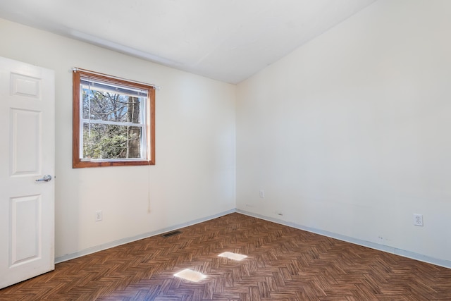 unfurnished room featuring visible vents and baseboards