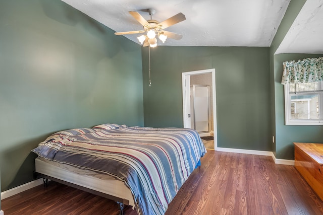 bedroom featuring connected bathroom, ceiling fan, baseboards, lofted ceiling, and wood finished floors