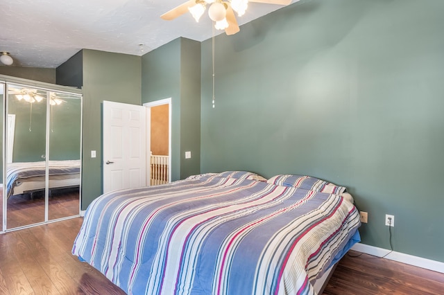 bedroom featuring a ceiling fan, wood finished floors, baseboards, a closet, and a textured ceiling