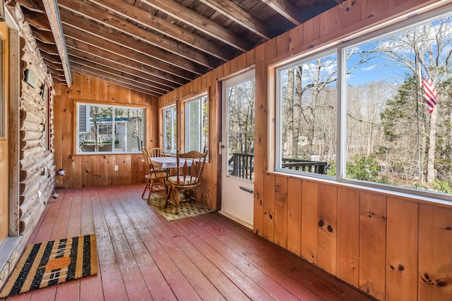 unfurnished sunroom with lofted ceiling