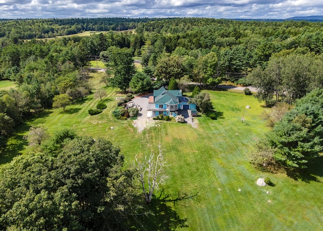 drone / aerial view featuring a wooded view