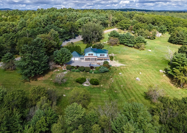 drone / aerial view with a wooded view