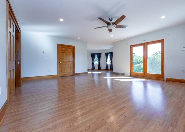 unfurnished living room featuring a ceiling fan, recessed lighting, baseboards, and light wood finished floors