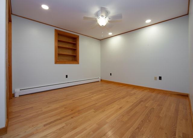 spare room featuring light wood finished floors, baseboards, crown molding, a baseboard heating unit, and recessed lighting