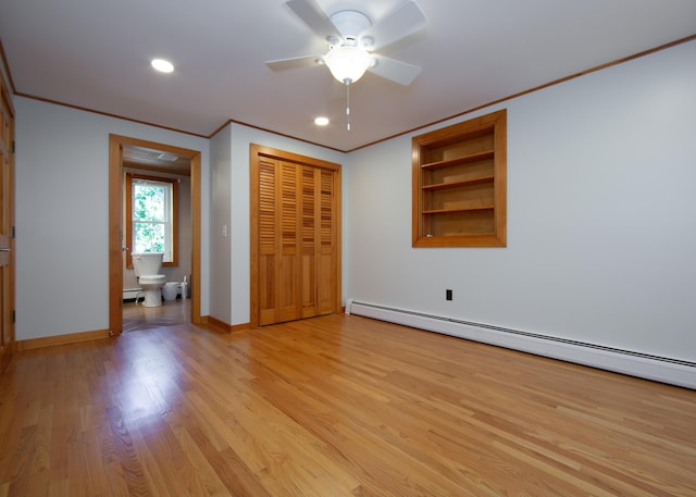 unfurnished bedroom featuring a baseboard radiator, baseboards, light wood-style floors, a closet, and crown molding