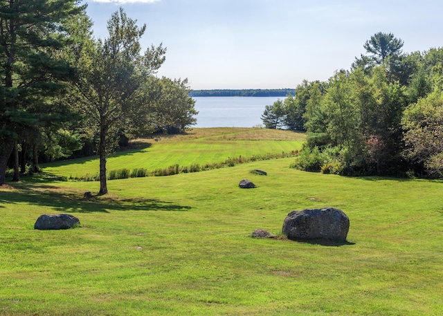 exterior space featuring a lawn and a water view