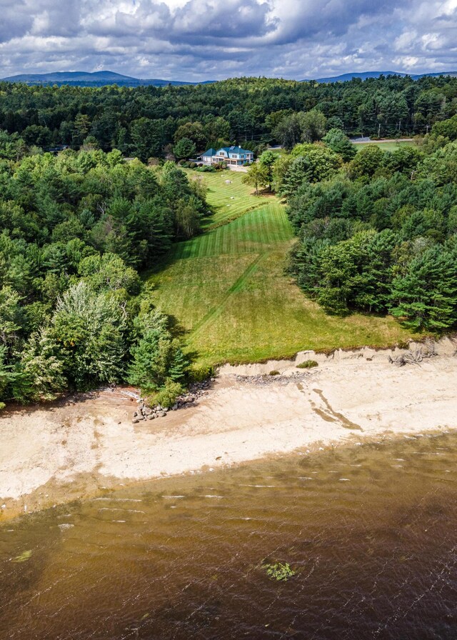 birds eye view of property featuring a view of trees