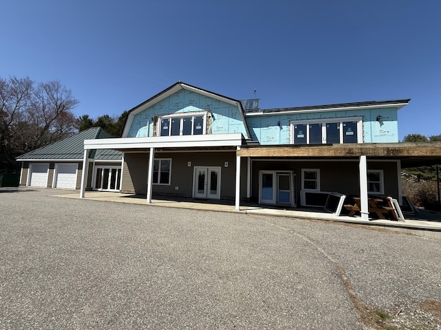 547 Mariaville Rd, Ellsworth, ME 04605 - back of property featuring french doors, a garage, and covered porch