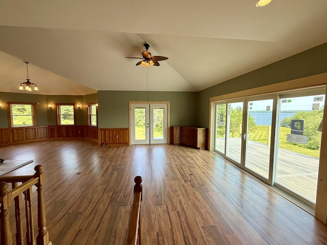 547 Mariaville Rd, Ellsworth, ME 04605 - unfurnished living room with ceiling fan, wood finished floors, healthy amount of natural light, wainscoting, and high vaulted ceiling