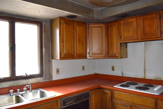 kitchen featuring a sink, black dishwasher, light countertops, white electric cooktop, and brown cabinets