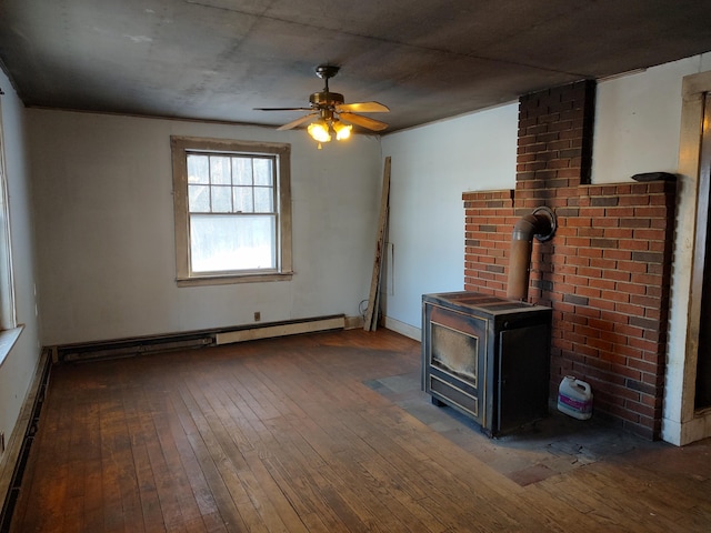 unfurnished living room featuring ceiling fan, hardwood / wood-style floors, baseboard heating, and a wood stove