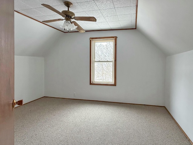 additional living space featuring lofted ceiling, baseboards, a ceiling fan, and carpet flooring