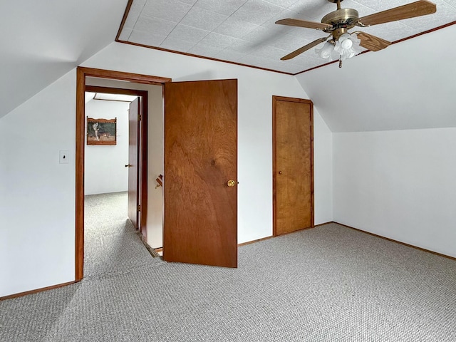 bonus room with lofted ceiling, ceiling fan, baseboards, and carpet flooring