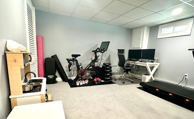 workout room with carpet floors and a paneled ceiling