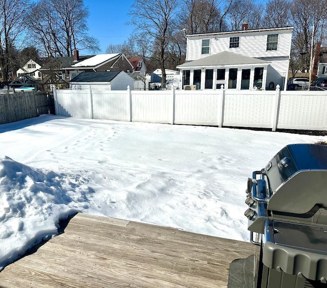 yard covered in snow featuring a fenced backyard