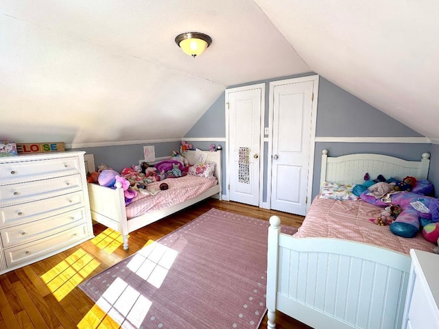 bedroom featuring vaulted ceiling and wood finished floors