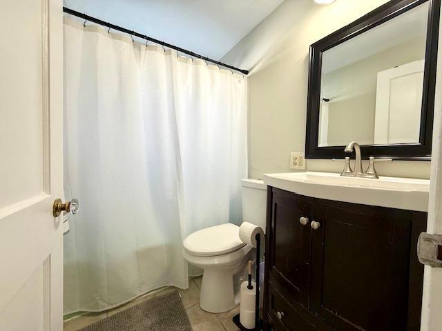 full bathroom with toilet, vanity, a shower with shower curtain, and tile patterned floors