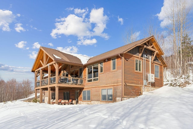 view of snow covered rear of property