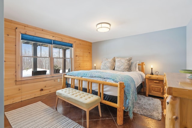 bedroom featuring wooden walls