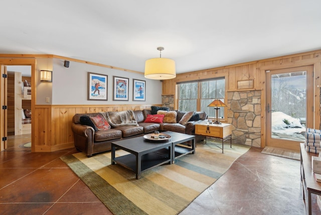 living area with wood walls and a wainscoted wall