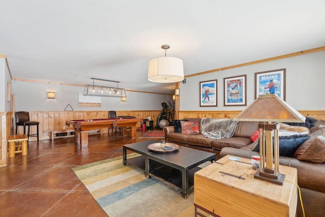 living room with wainscoting, billiards, and finished concrete floors