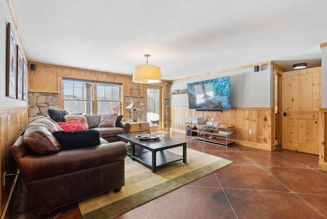 living area featuring a wainscoted wall, concrete floors, and wood walls