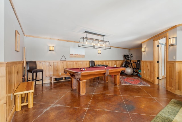 recreation room with wood walls, wainscoting, billiards, and crown molding