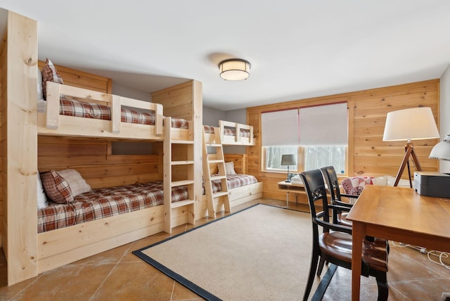 bedroom featuring wood walls